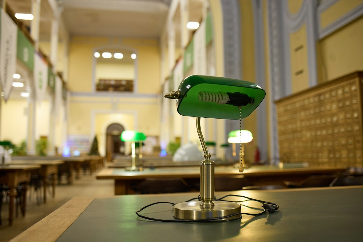 Brass desk lamp with a green shade